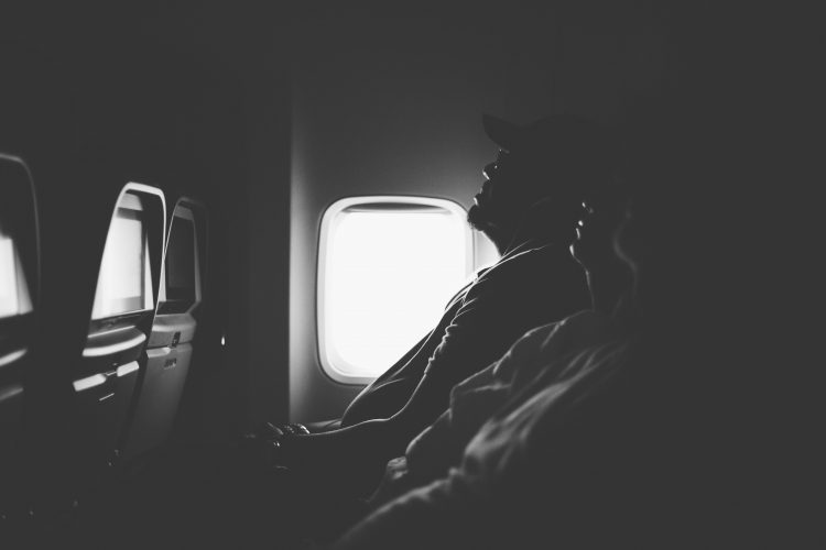 A man sleeping in a plane.