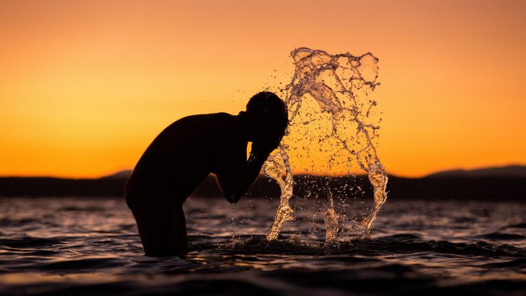 A man washing his face.